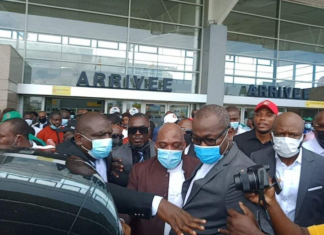 Ex-Ivorian officials return home after decade in exile