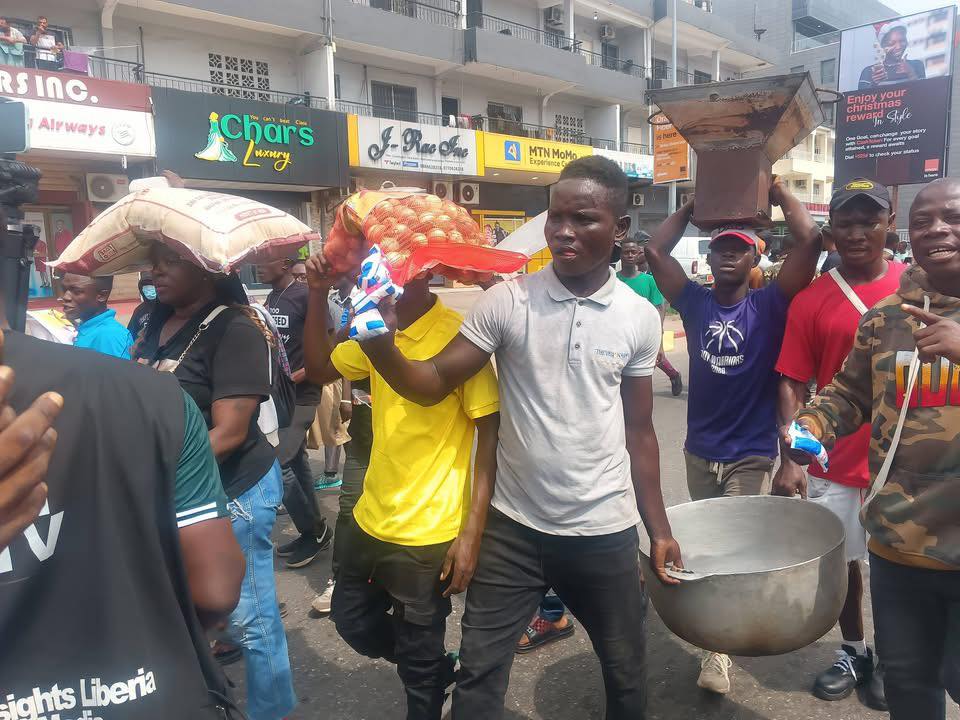 Protesters carrying cooking Pot